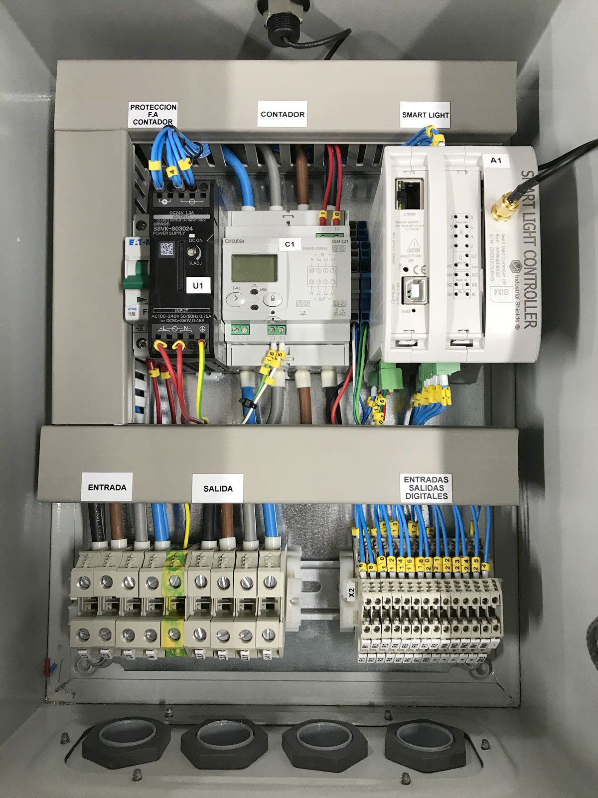 Reference lighting cabinet with a power supply U1, a Circutor CEM-C21 network analyzer C1 and a Smart Light Controller A1 above the terminal blocks