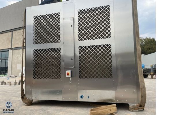 Side of the HVAC unit with the control cabinet door and a red push button