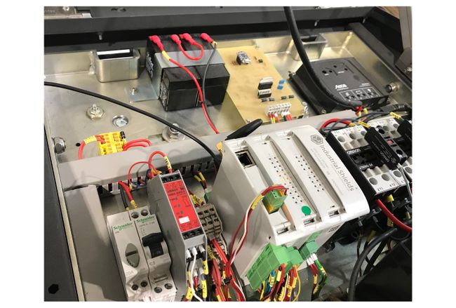 Control cabinet under the lid of the compacting litter bin, with an Industrial Shields ESP32 PLC, contactors, breakers and a battery