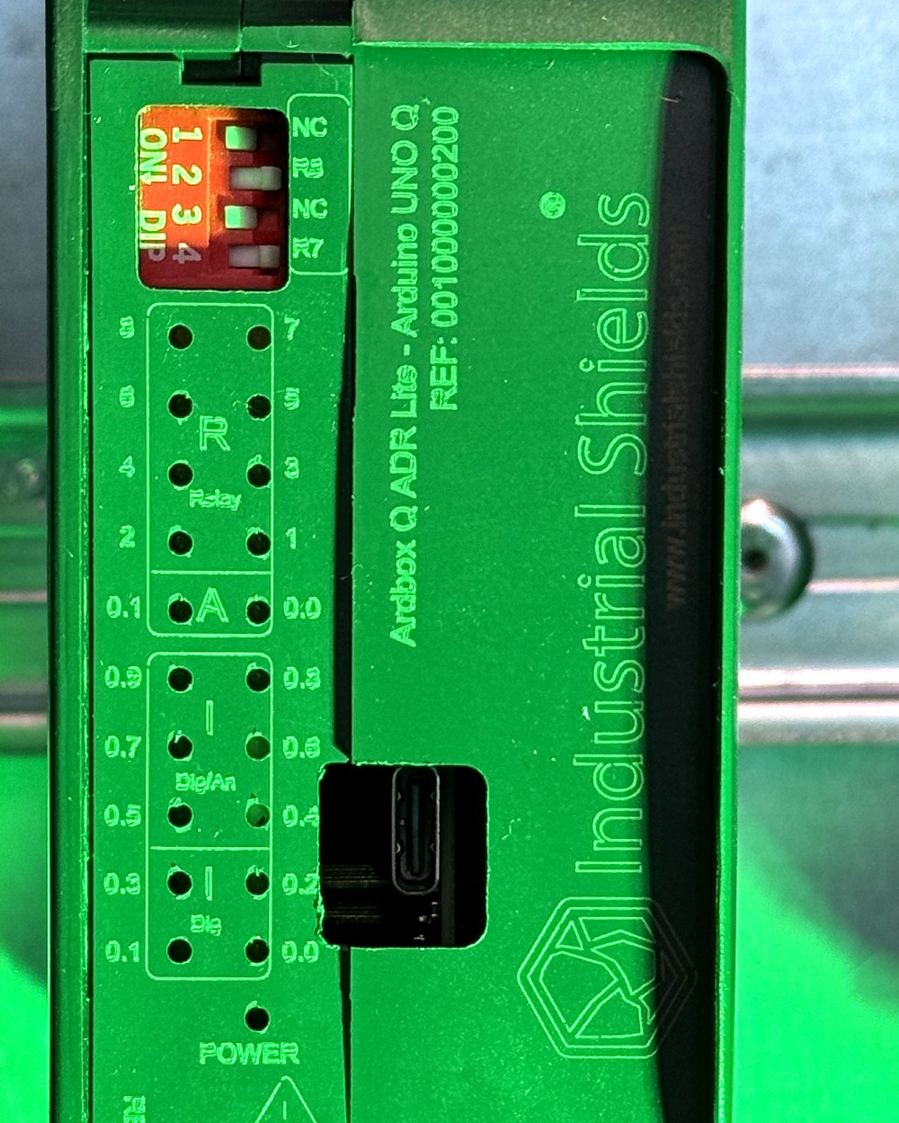 Close-up of the Ardbox Q industrial PLC front panel with USB-C port and DIP switches