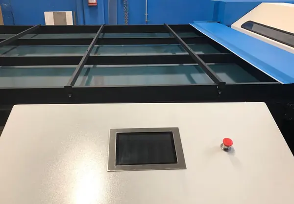 Panel PC based on Raspberry Pi built into the housing of the production machine, next to a red push button