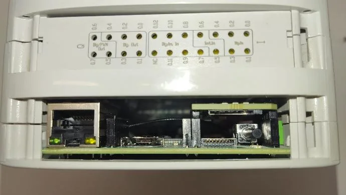 ESP32 PLC with the Ethernet port cover removed, showing the inside where the SIM card slot sits above the reset button