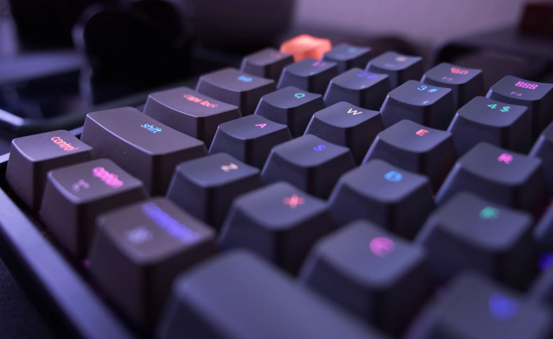 Close-up of a backlit physical keyboard, the device that an on-screen keyboard replaces on a touch panel